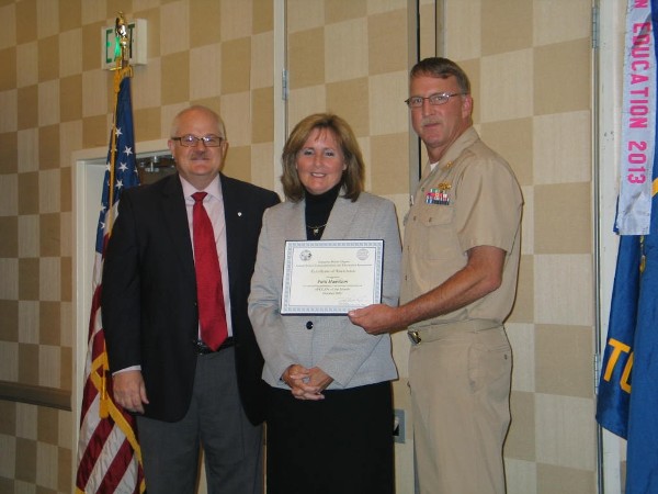 Lt. Cmdr. Doug Vanderlip, USN (r), chapter president, and Steve Frazier present the Civilian AFCEAN of the Month Award for October to Patti Hamilton, president of Hamilton Consulting Solutions Corp.